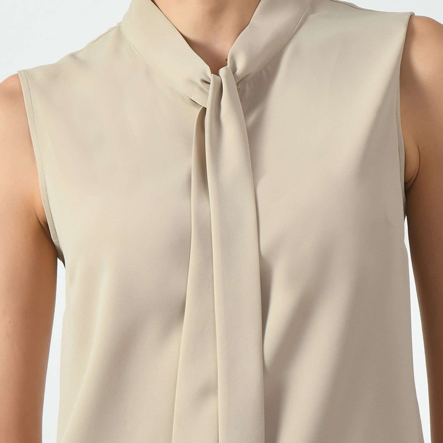 Light Beige Sleeveless Top With Knot, office wear tops , stylish formal tops , best tops for work, stylish work tops , trendy tops for women ,modern tops for office, formal tops for women, tops for women stylish, top with knots, sleveless top